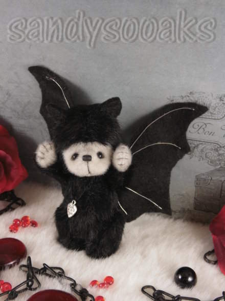 bat hugging teddy bear